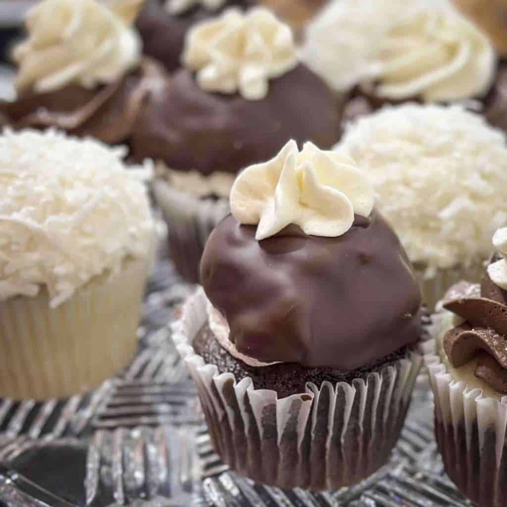 Decadent chocolate cupcakes topped with white and dark chocolate frosting, perfect for dessert lovers and special occasions.