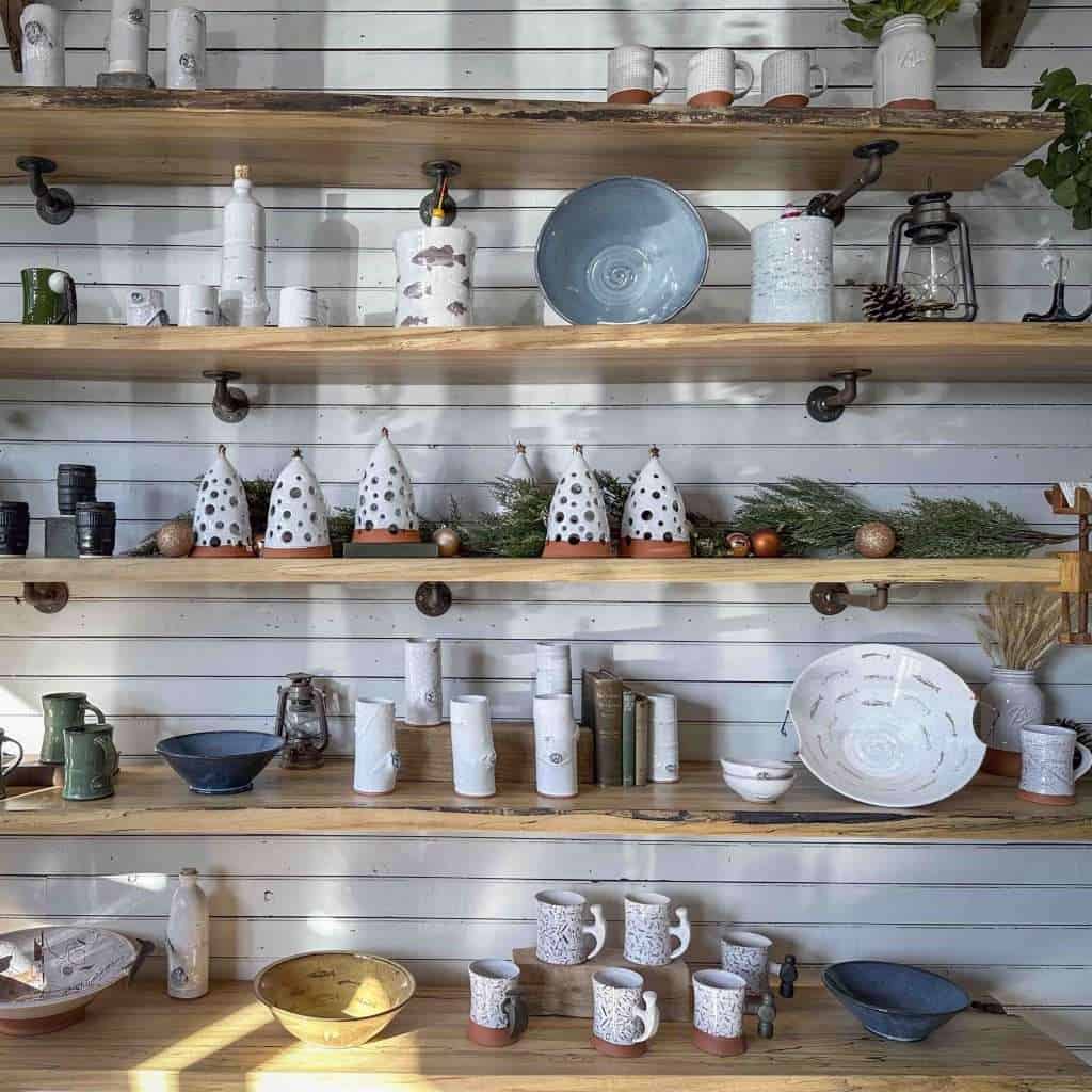 a wall filled with various pieces of hand-made pottery