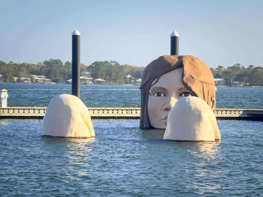 Lady in the Bay sculpture emerging from the water at Barber Marina in Elberta, Alabama