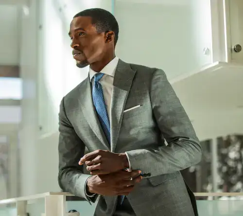 Business professional in formal attire discussing pricing options at a conference.