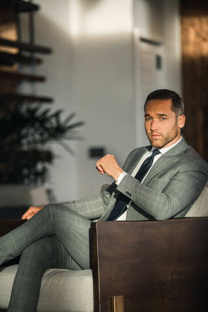 Business professional in a suit discussing pricing strategies.