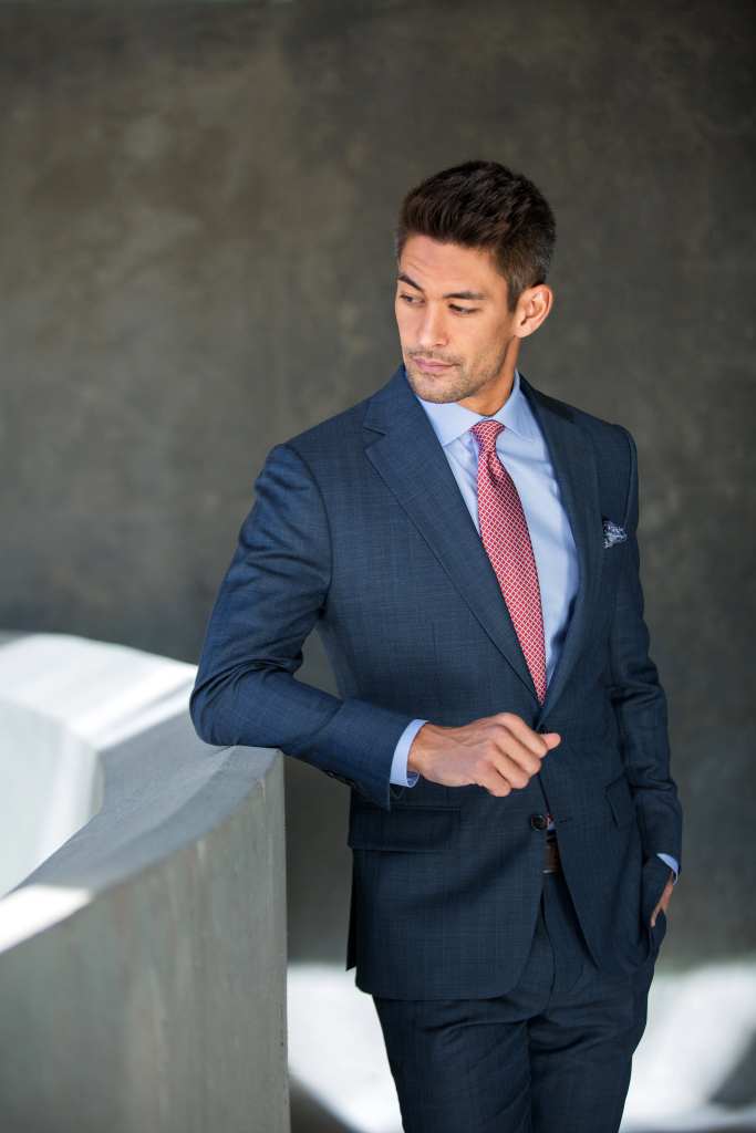 Business professional in tailored suit for pricing consultation.