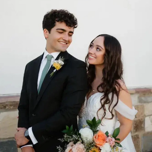 Happy wedding couple smiling at each other during their special day.