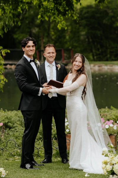 Bride and groom exchanging vows during outdoor wedding ceremony.