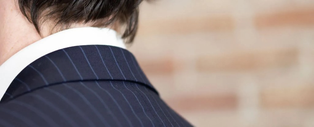 Business professional suit with pinstripes and white shirt.