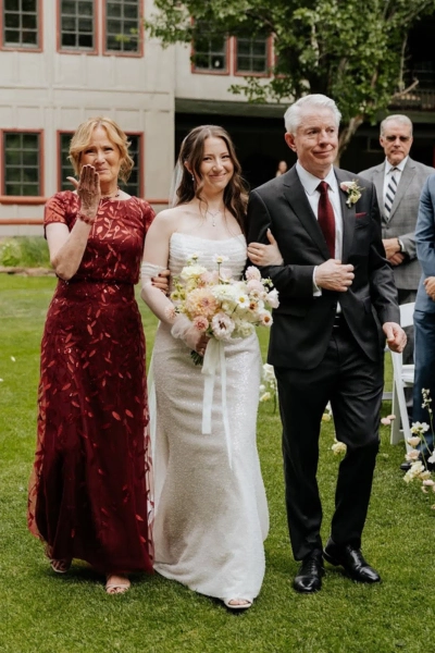 Elegant wedding at H.M. Cole with bride, groom, and family in a garden setting.