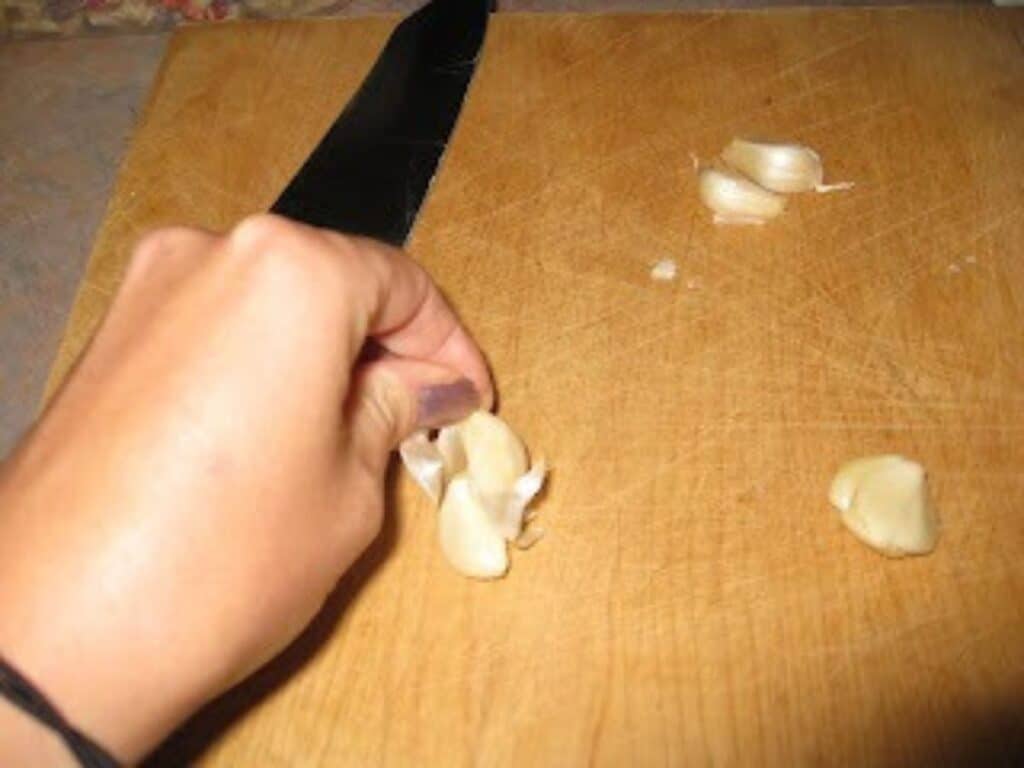 Image shows getting the skin of garlic.