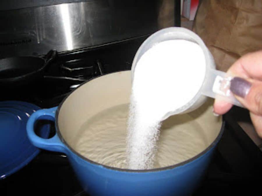 Image shows sugar added to water.