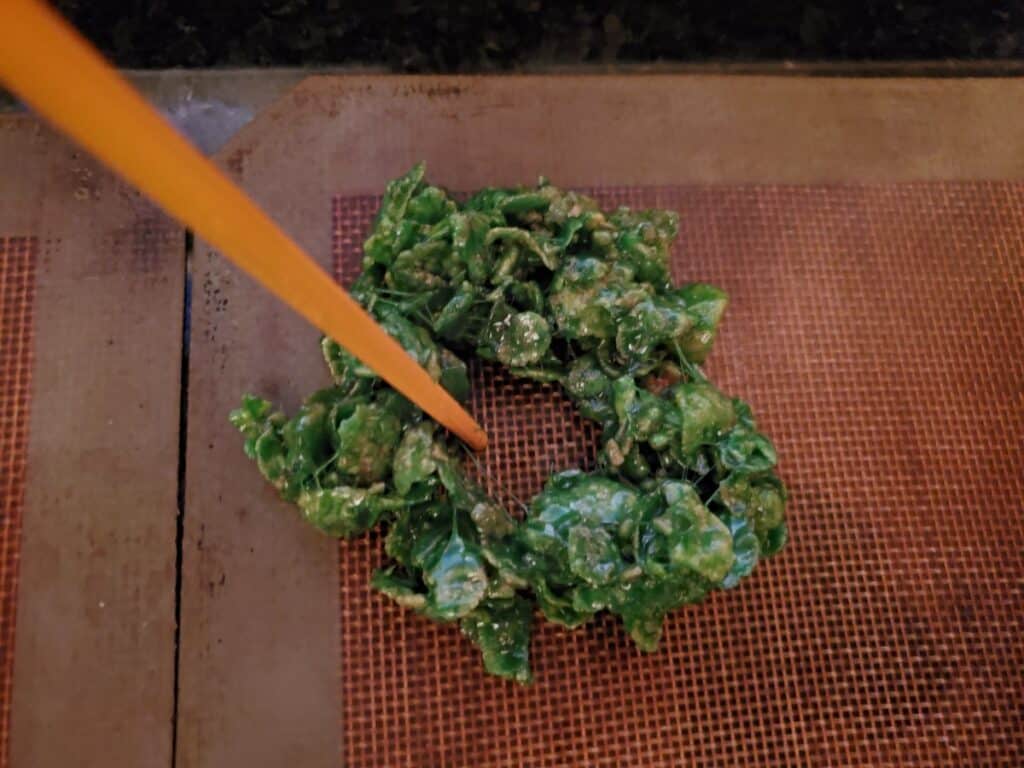 Chopstick shaping a holly wreath.