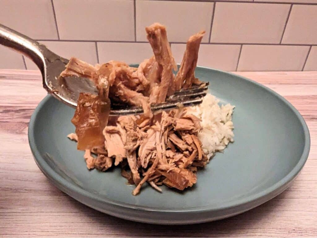 Fork holding garlic roast pork.