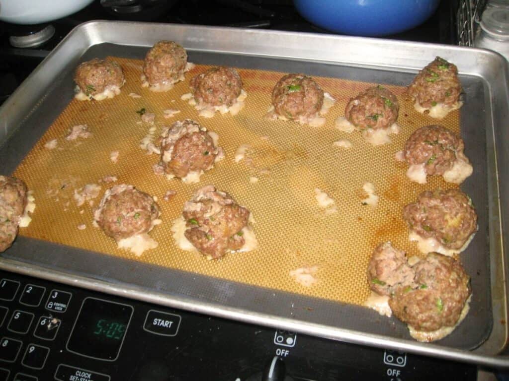Image shows classic Italian meatballs on Silpat.