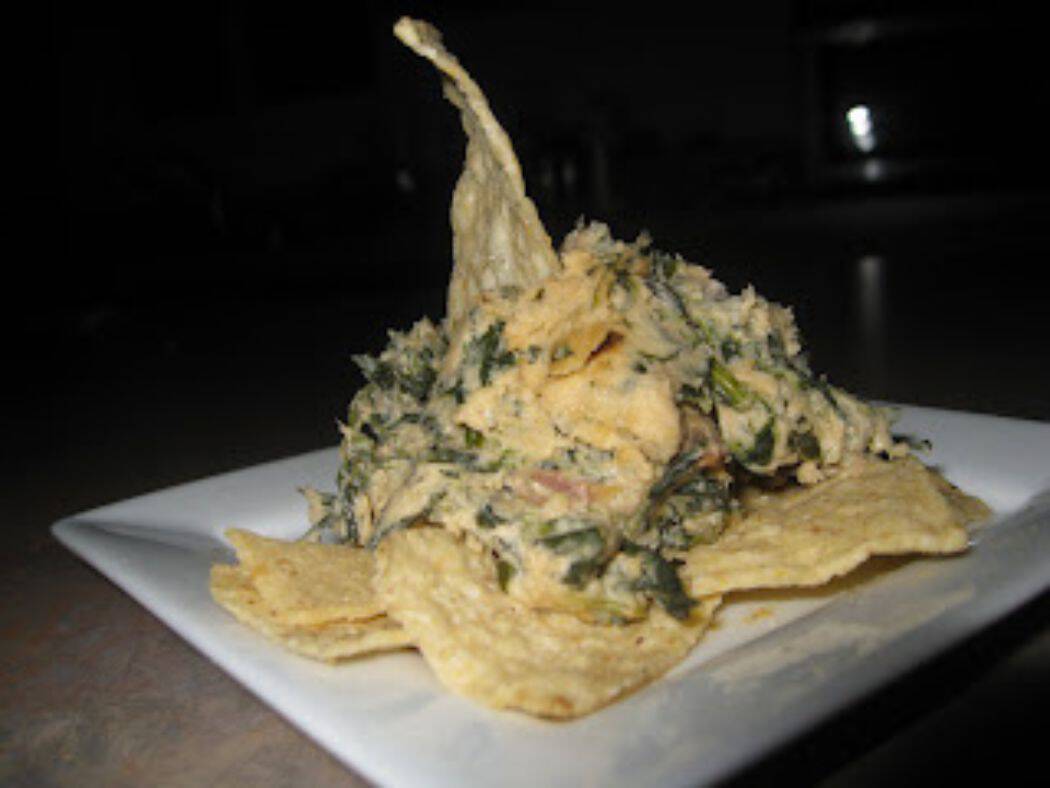 Image shows cheesy hot spinach dip.