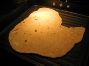 Image shows grilled flatbread dough.