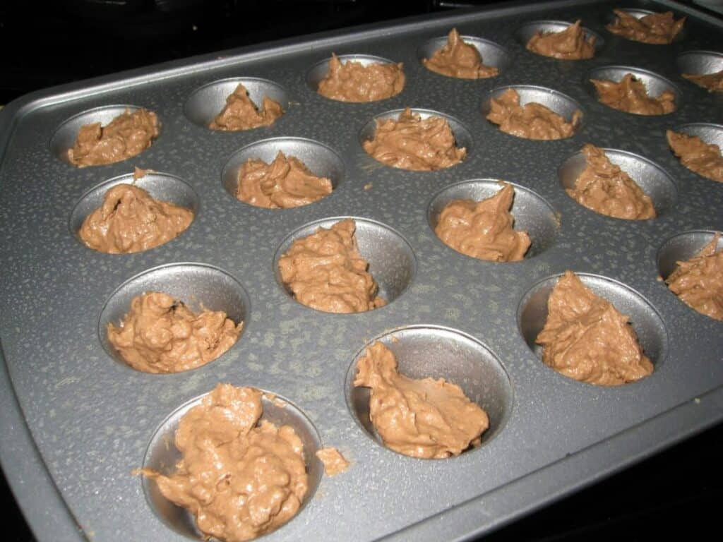 Image shows ookie batter in a mini muffin tin.