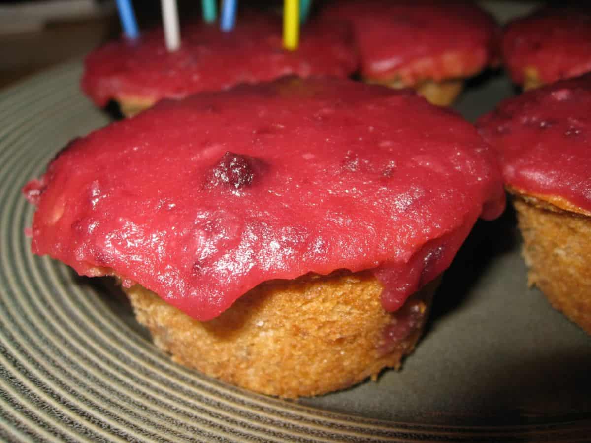 Image shows strawberry cupcake with cherry glaze on a serving dish.