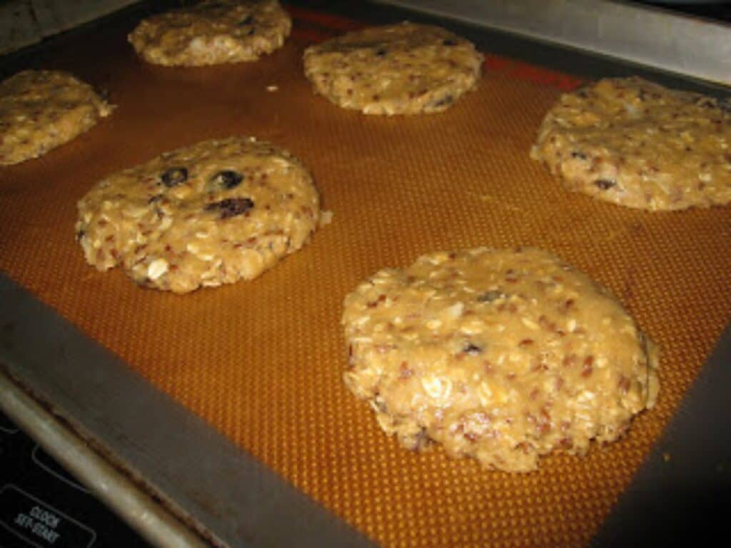 Image shows batch of uncooked cookies on a baking sheet.