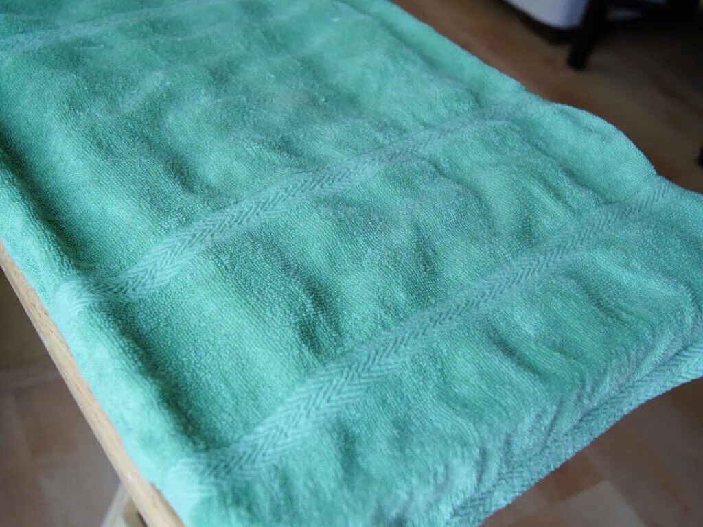 Image shows kitchen towel covering the bagel dogs.