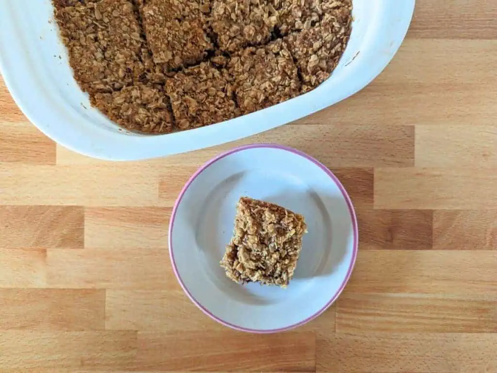 Image shows an Overhead of a raspberry jam bar on a plate.