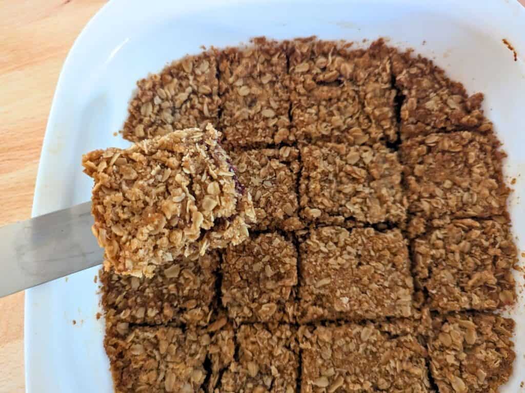 Image shows an Overhead of a spatula holding a bar cookie.