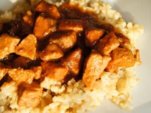 Image shows peanut chicken with rice.