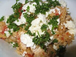 Image shows mediterranean chicken couscous with feta cheese.