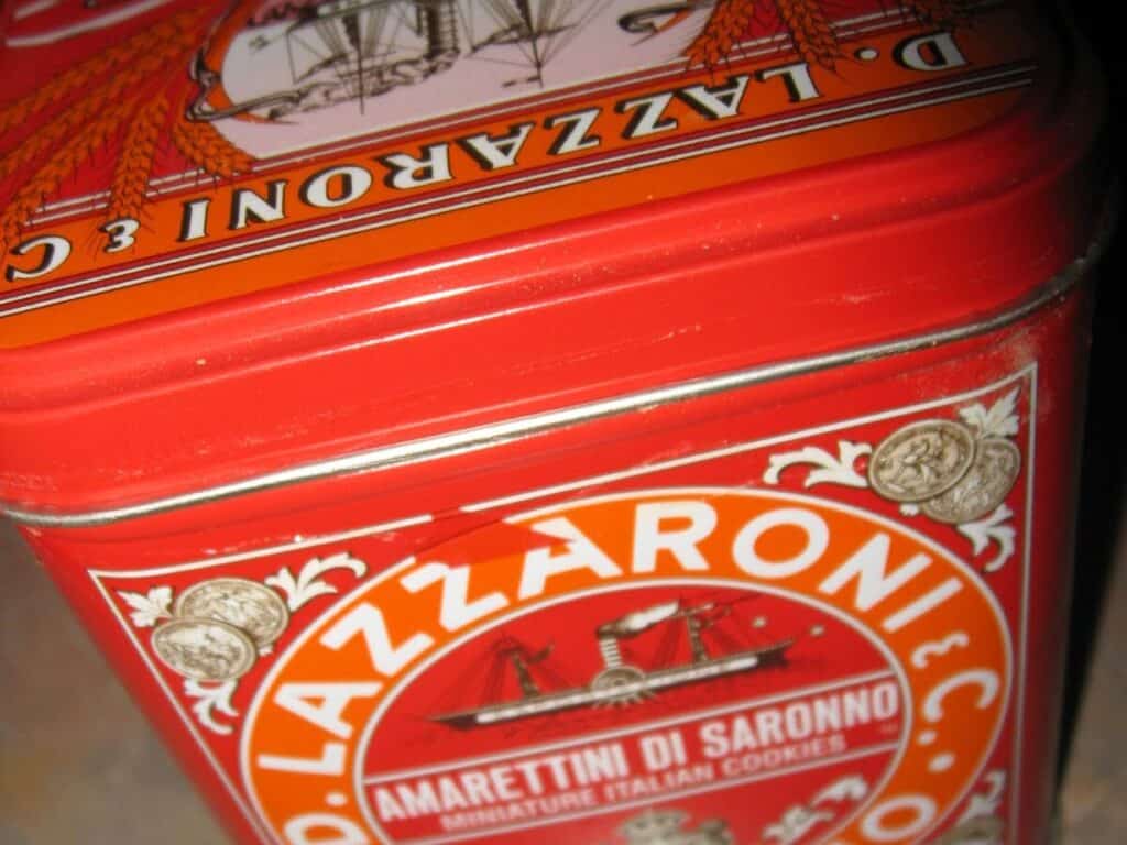 Image shows Amaretti cookies in their container.