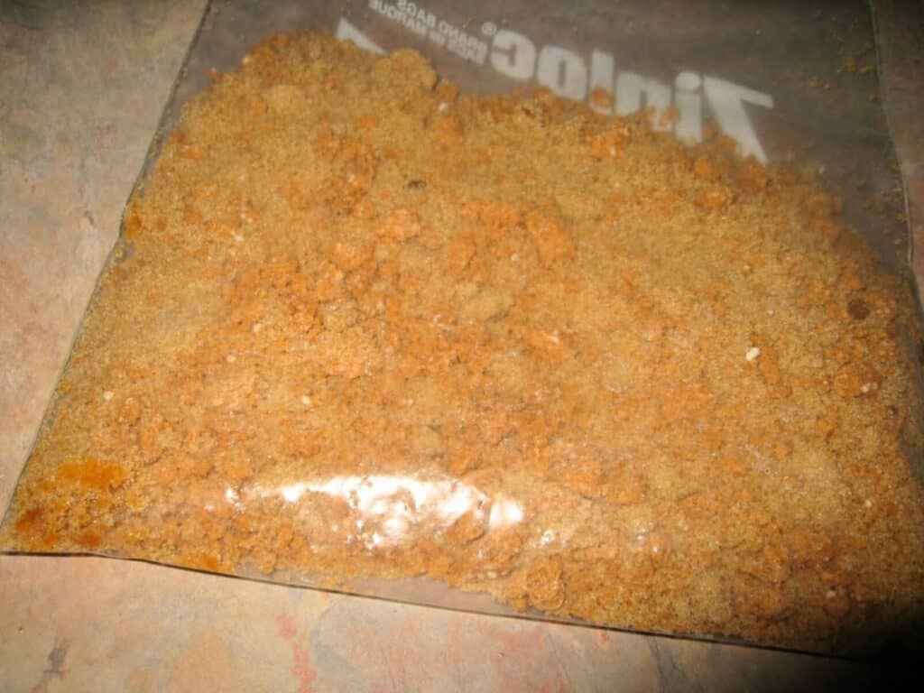 Image shows crushed Amaretti cookies in a plastic bag.