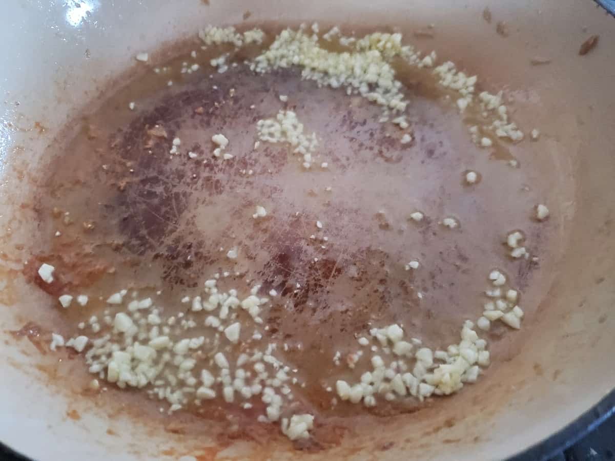 Garlic cooking in a skillet.