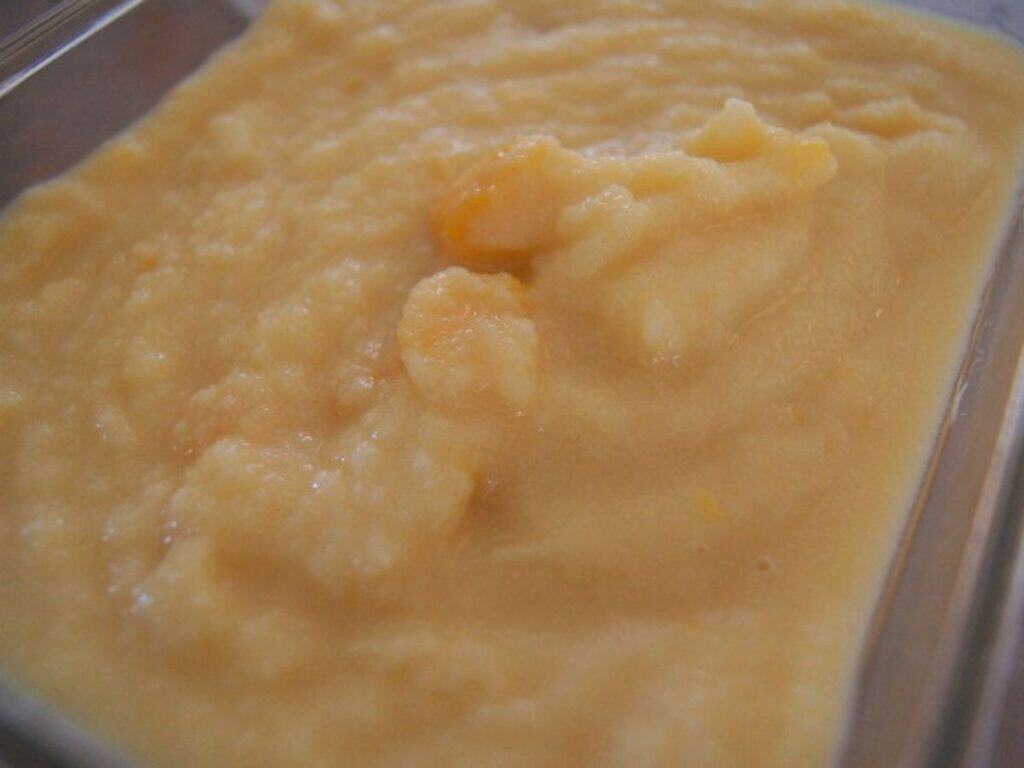 Image shows peach coconut milk ice cream ready to freeze.