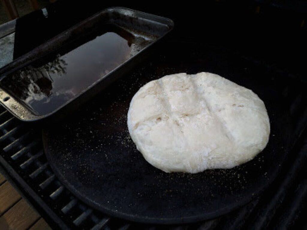 Image shows bread baking on the grill.