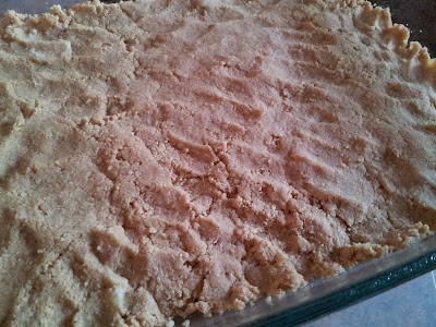 Graham cracker shortbread base pressed into a baking dish.
