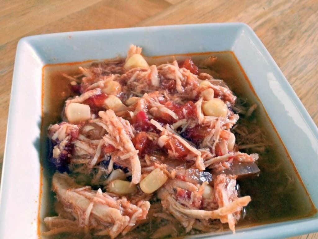 Five Minute Crock Pot Tortilla Soup Image shows tortilla soup in a bowl.