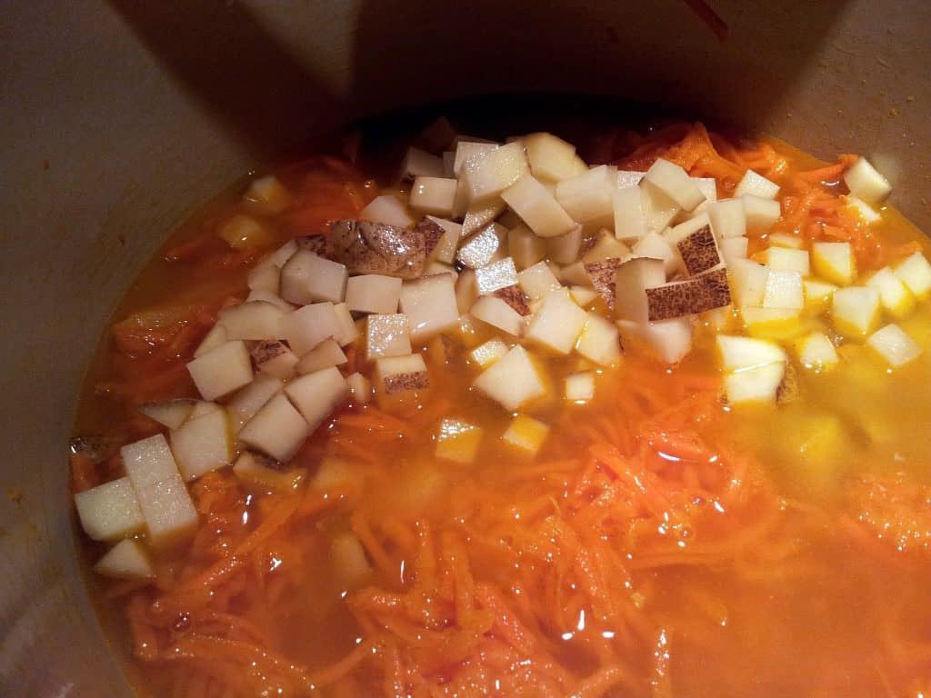 Potatoes and stock for carrot ginger soup Bring the items to a boil, noting that the stock just covers the veggies