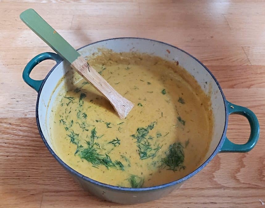 Pot of carrot ginger soup with spoon