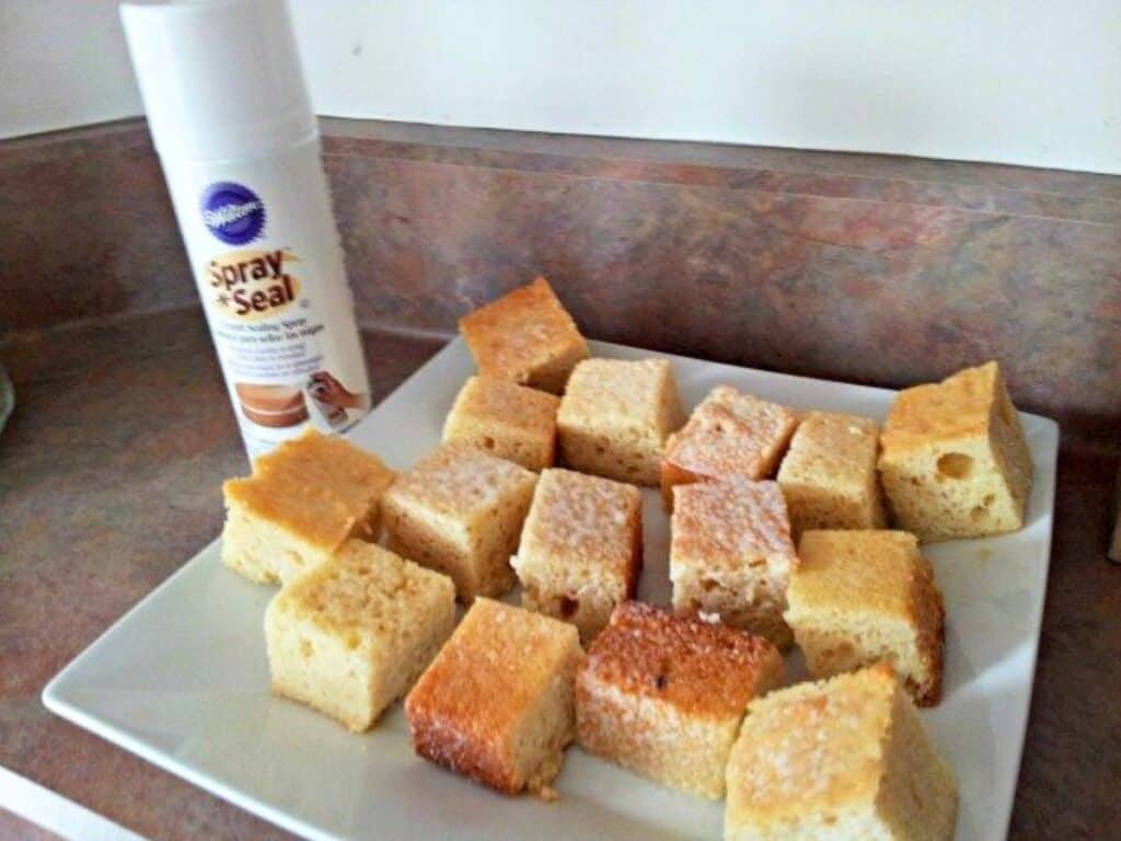 Image shows sliced cake on a plate beside Wilton cake sealer.