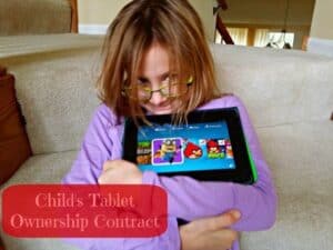 Little Miss hugging her Kindle Fire
