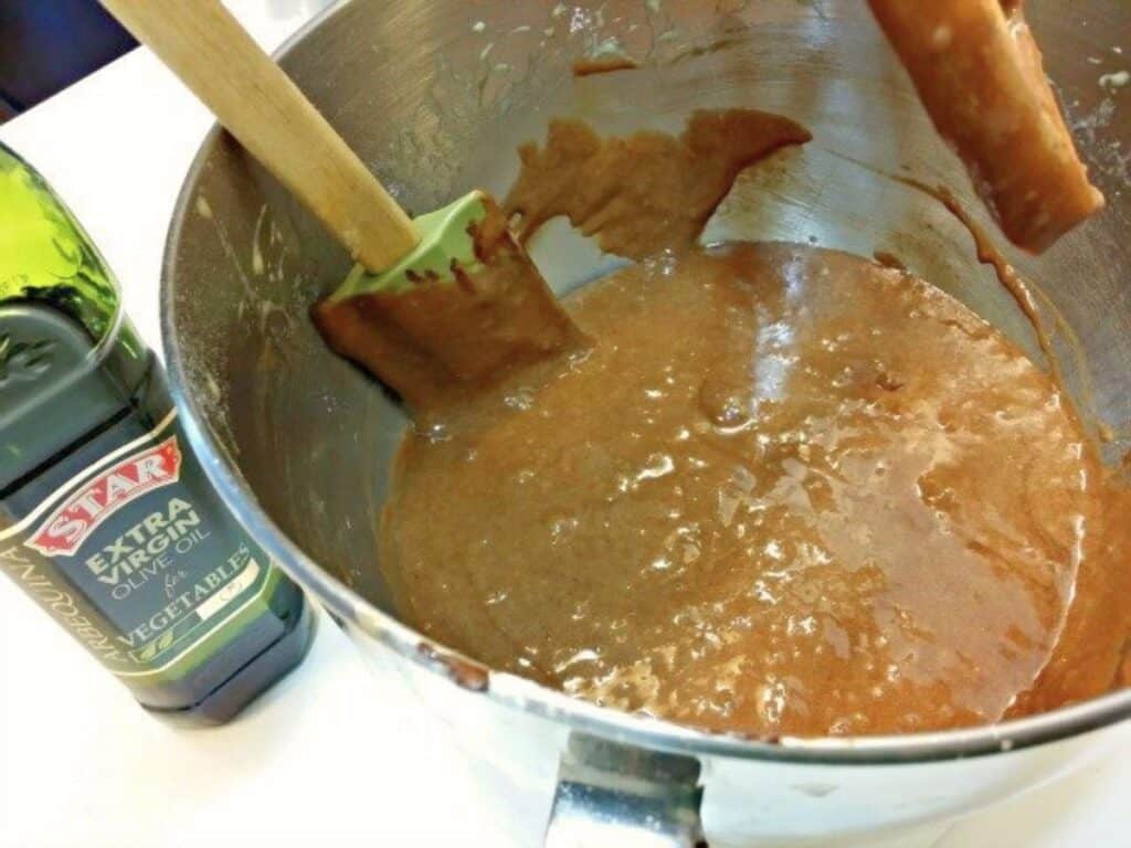 Image shows bowl with mixtures for chocolate olive oil cake.