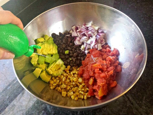 Adding lime juice to black bean and corn salsa