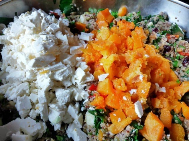 Add feta and butternut squash to harvest quinoa salad and stir