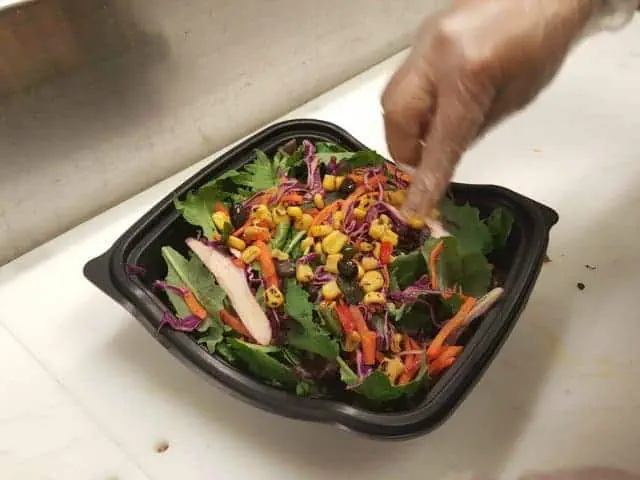 Adding tomatoes to the Chick-fil-A southwest salad