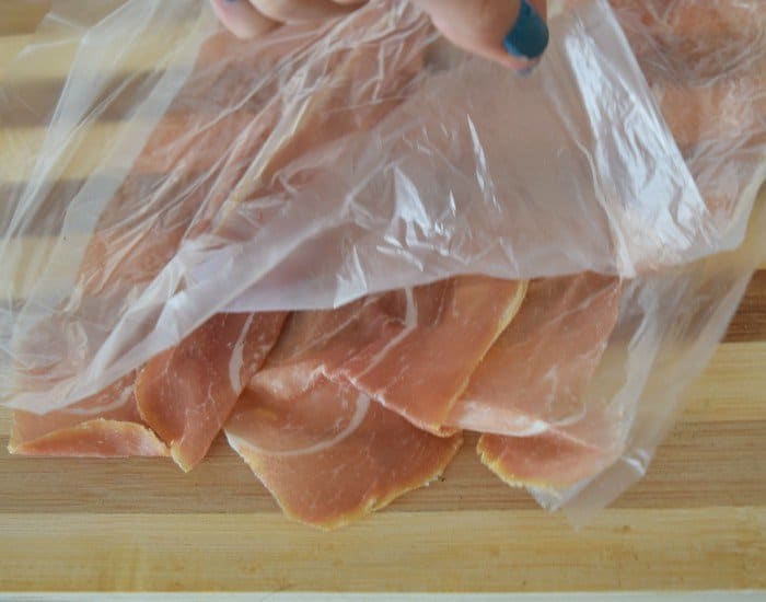 Add extra plastic to protect prosciutto at the deli counter