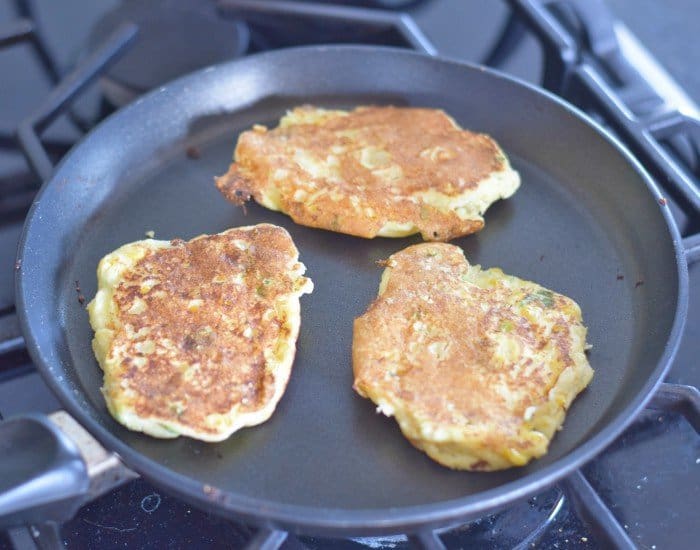 Flip corn fritters after golden on one side