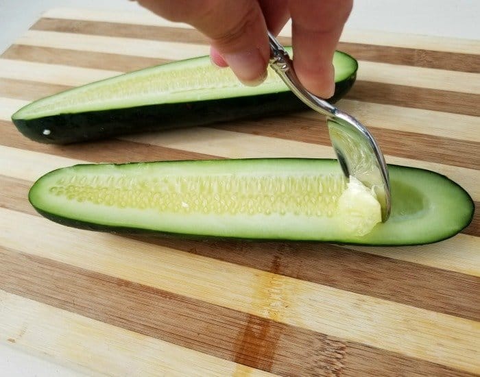 Use a spoon to seed a cucumber
