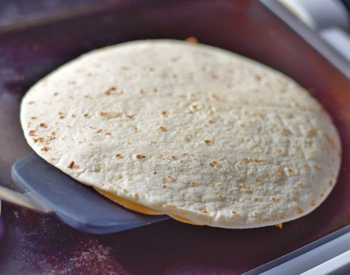 Use large spatula to flip quesadillas