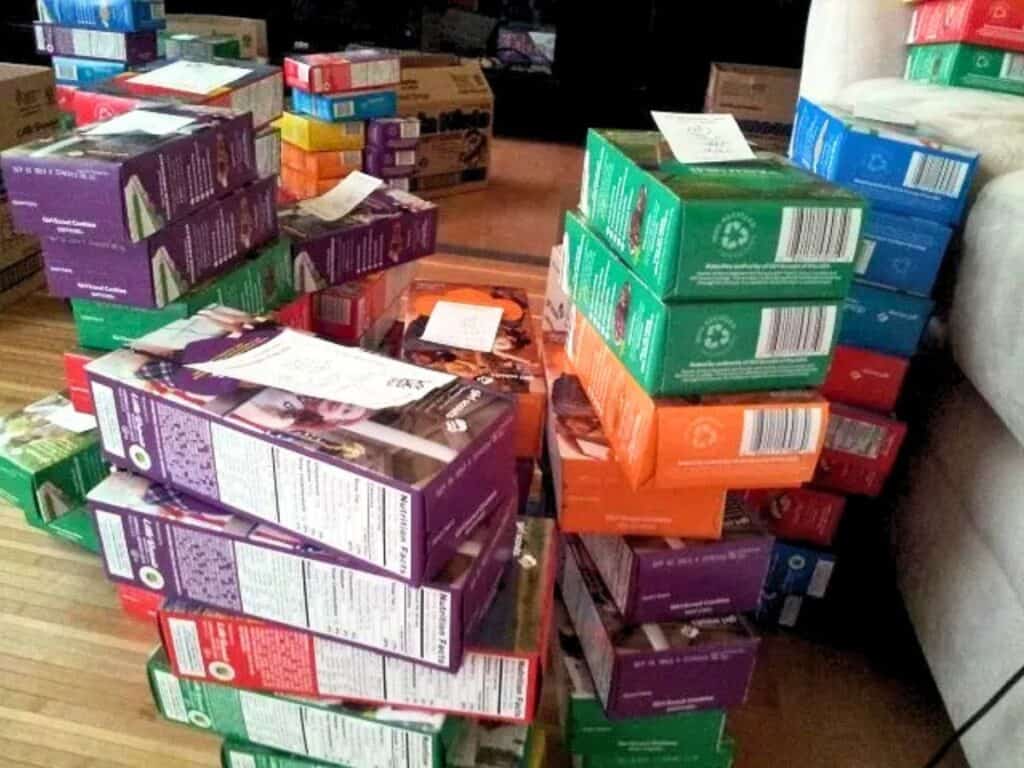 Image shows boxes of Girl Scout cookies piled.