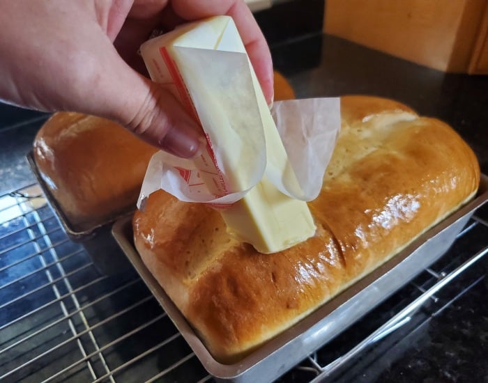 Rub butter over the bread tops