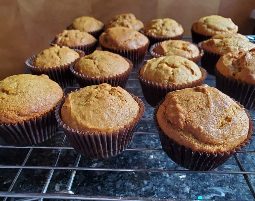 Freshly baked pumpkin muffins on a rack
