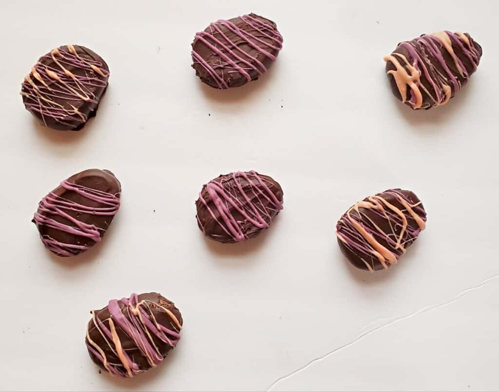 Cookie dough easter egg truffles on a white background.