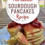 Head on of pancakes with a bite on a fork on the plate