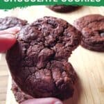 Closeup of a hand holding a brookie with the text peppermint chocolate cookies.